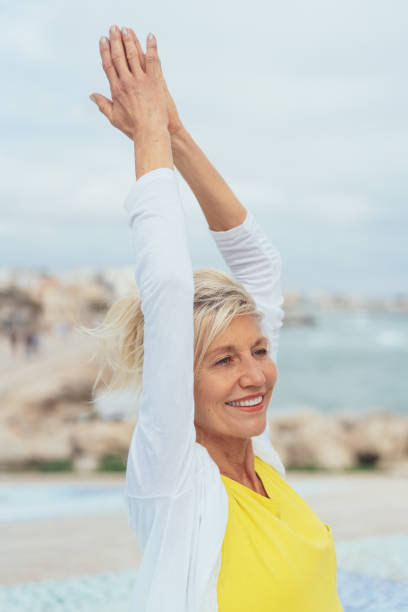 istock Happy healthy woman doing stretching exercises 1076784120