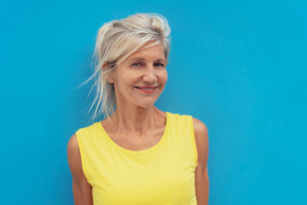 istock Cheerful mature woman against blue background 1076784850
