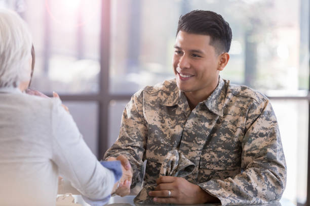 military soldier greets female therapist - good defense imagens e fotografias de stock