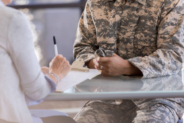 istock Female therapist talks with military solider 1076785798