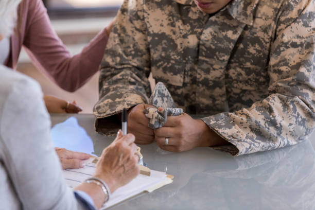 istock Wife comforts soldier husband during therapy session 1076785820
