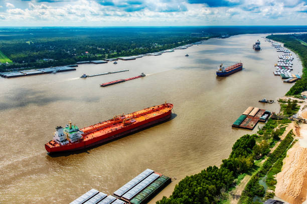 Oil Tankers on the Mississippi A line of oil tankers transporting fuel to the refineries located along the Mississippi River just north of New Orleans, Louisiana. refinery photos stock pictures, royalty-free photos & images