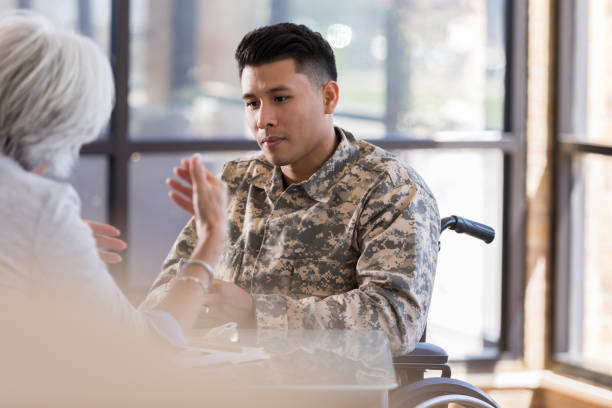 istock Female therapist talks with upset young soldier 1076785842