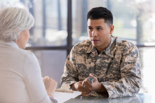 istock Serious young soldier discusses issues with counselor 1076785868
