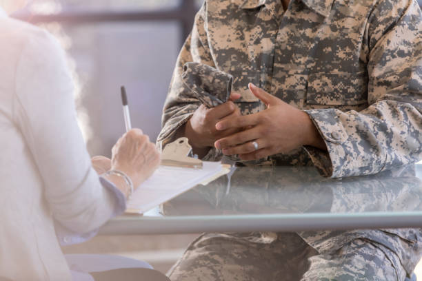 istock Unrecognizable soldier talks with female therapist 1076785884