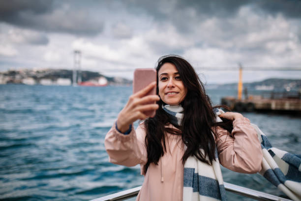 istock Woman taking selfie at Bosphorus 1076785900