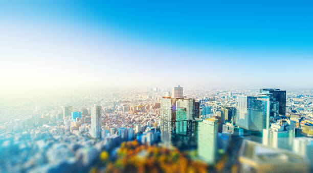tokyo skyline aerial view with tilt shift effect Asia business concept for real estate and corporate construction - panoramic city skyline aerial view under blue sky & sun in Shinjuku Tokyo, Japan with tilt shift, miniature, blur effect tilt shift stock pictures, royalty-free photos & images