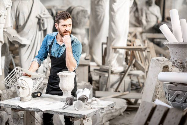 istock Sculptor working with sculptuers in the studio 1076791092