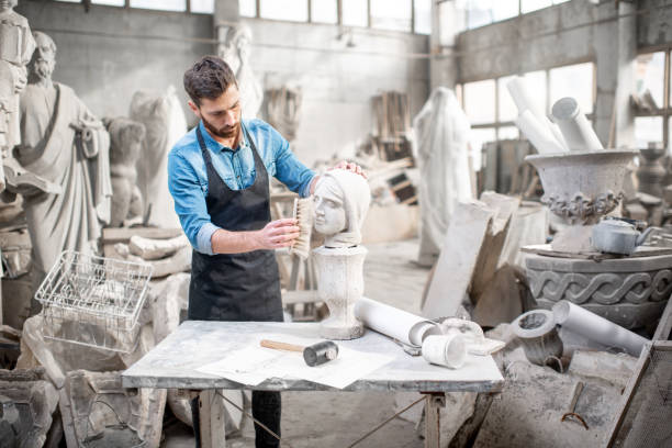 Sculptor working with sculpture in the studio