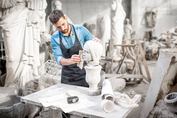 istock Sculptor working with sculpture in the studio 1076791586