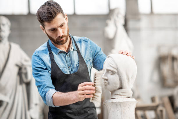 istock Sculptor working with sculpture in the studio 1076791624