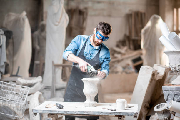 istock Sculptor working with sculptures in the studio 1076792924