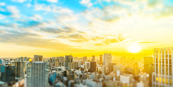 Asia business concept for real estate and corporate construction - panoramic city skyline aerial view under blue sky & sun in Tokyo, Japan with tilt shift, miniature, blur effect