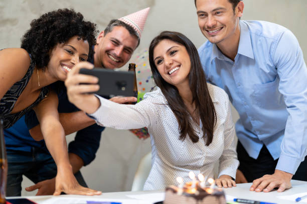 istock Business colleagues taking a selfie at birthday party at work 1076796208