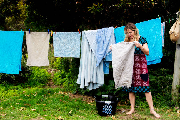 istock Woman hangs laundry on a clothesline 1076796476