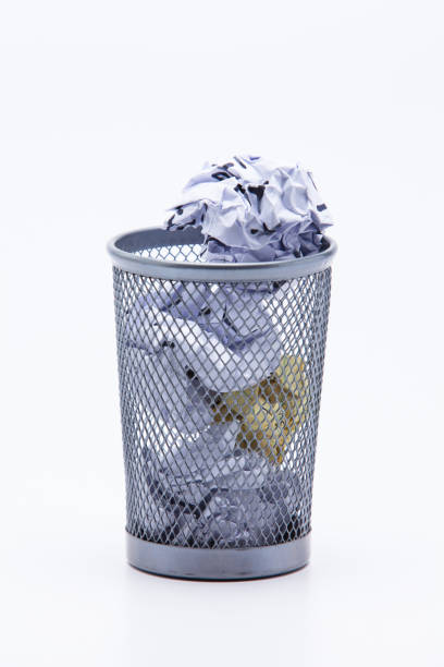 istock Crumpled Papers In Basket Over White Background 1076796694