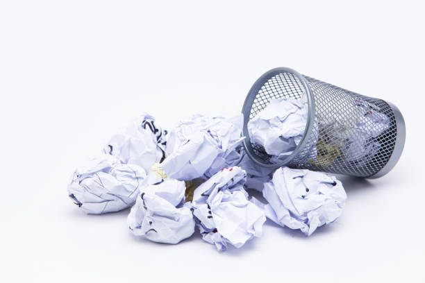 istock Crumpled Papers In Basket Over White Background 1076796800