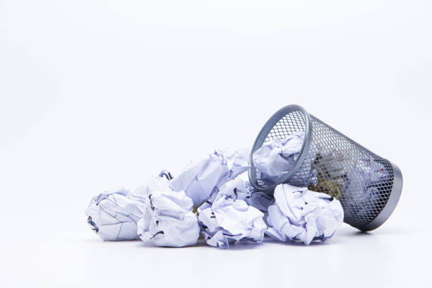 istock Crumpled Papers In Basket Over White Background 1076796870