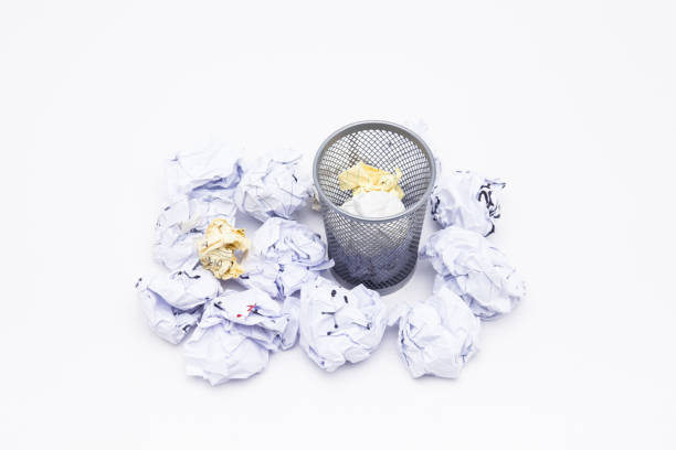 istock Crumpled Papers In Basket Over White Background 1076796992