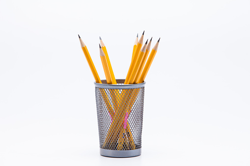 Group of pencils in pencil holder on white