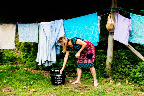 istock Woman hangs laundry on a clothesline 1076799150