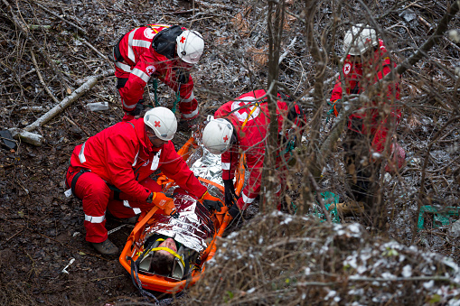 Sofia, Bulgaria - 5 December 2017: Paramedics from mountain rescue service provide first aid during a training for saving a person in accident in the forest.