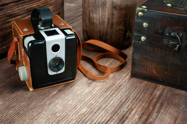 istock Retro camera on wooden background 1076803202