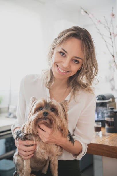istock Cheerful woman holding pet dog 1076803928