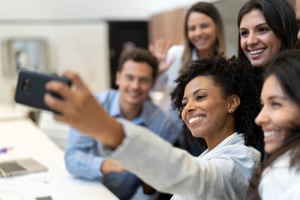 Business colleagues taking a selfie at work