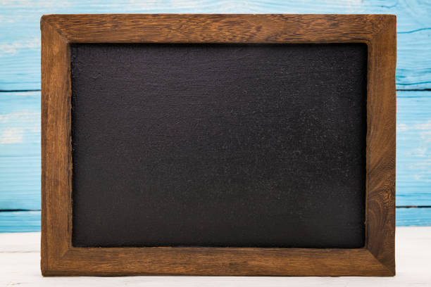 Blank blackboard with wooden frame and wooden blue background