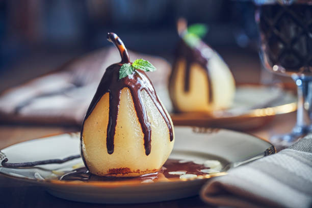 Poached Pears in Vanilla Lemon Syrup glazed with Dark Chocolate Poached Pears in Vanilla Lemon Syrup glazed with Dark Chocolate pear dessert stock pictures, royalty-free photos & images