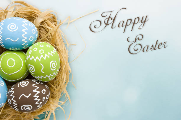 istock Easter card. Painted Easter eggs in nest on pale blue background 1076810462