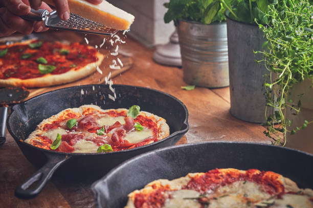 istock Preparing Homemade Pizza with Mozzarella in Domestic Kitchen 1076812892