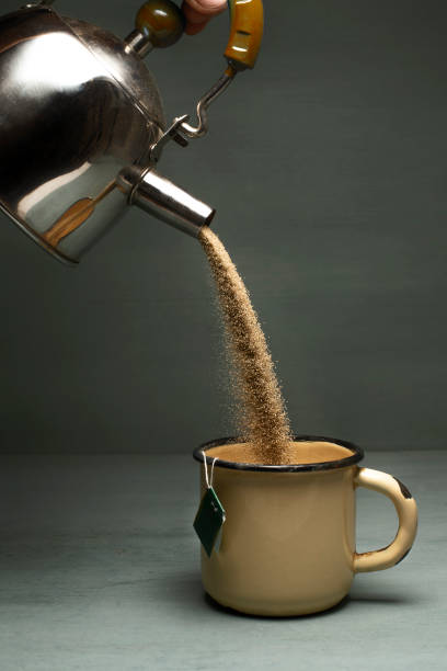 istock Sand pours from a teapot in a mug. Tea is brewed with sand 1076813530