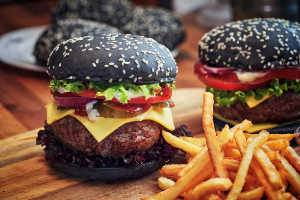 istock Black Burger Buns with Beef Pattie, Cheese, Tomato and Lettuce 1076814582