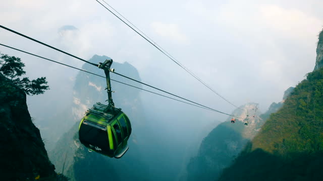 Cable cars moving up in mountain