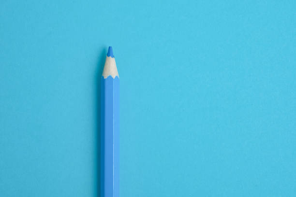 istock Blue pencil on blue paper background. Close up. 1076824618