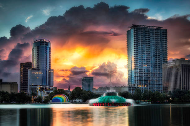 Lake Eola - Orlando Bursting sunset between buildings in downtown Orlando lake eola stock pictures, royalty-free photos & images