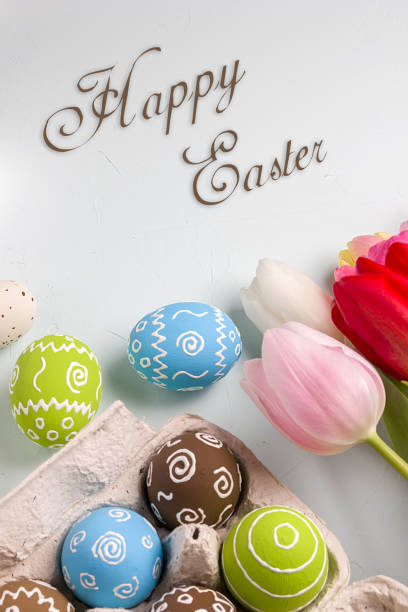 istock Painted easter eggs and branches of spring sakura closeup on a light blue background with space for congratulation 1076828348