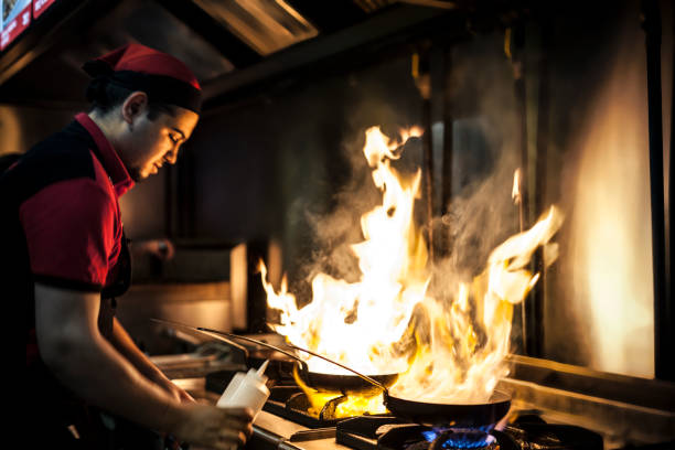 istock Chef flaming food at a restaurant 1076835760