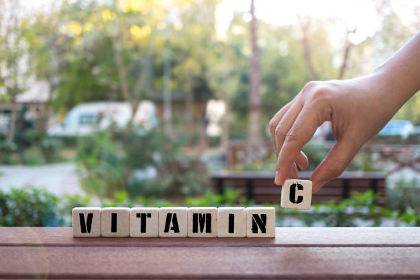 istock VITAMIN C Concept with alphabet blocks on wooden table. 1076836592