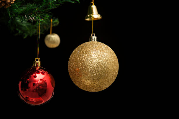 istock Red and Yellow Christmas Bauble on Black Background 1076839166