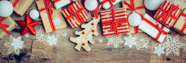 istock Christmas background with decorations and red gift boxes on the wooden board 1076839190