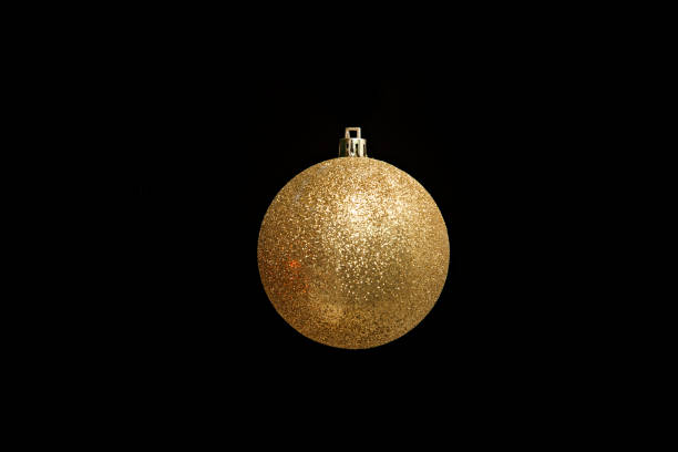 istock Yellow Christmas Bauble on Black Background 1076839762