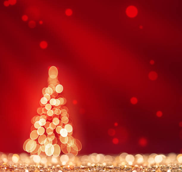 istock Red light and christmas tree on gold defocused sparkles 1076840806