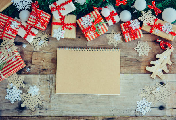 istock Christmas background with decorations and red gift boxes on the wooden board 1076841684