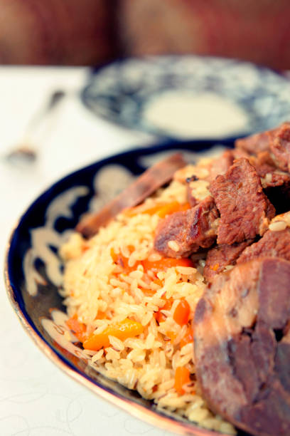istock Traditional pilaf on restaurant table, toned image 1076841964