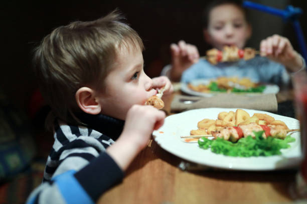 istock Kids eating kebab on skewers 1076846570