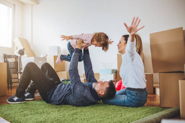 Cheerful family playing in a unpacked apartment
