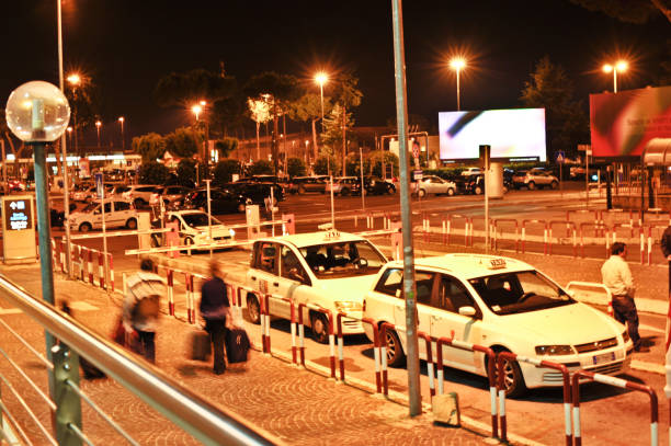 Passengers/travellers and taxis at night outside the arrival hall (Pick-up and drop-off point) of Thessaloniki Airport (IATA: SKG, ICAO: LGTS), Greece Passengers/travellers and taxis outside the arrival hall (Pick-up and drop-off point) of Thessaloniki Airport (IATA: SKG, ICAO: LGTS), Greece skg stock pictures, royalty-free photos & images